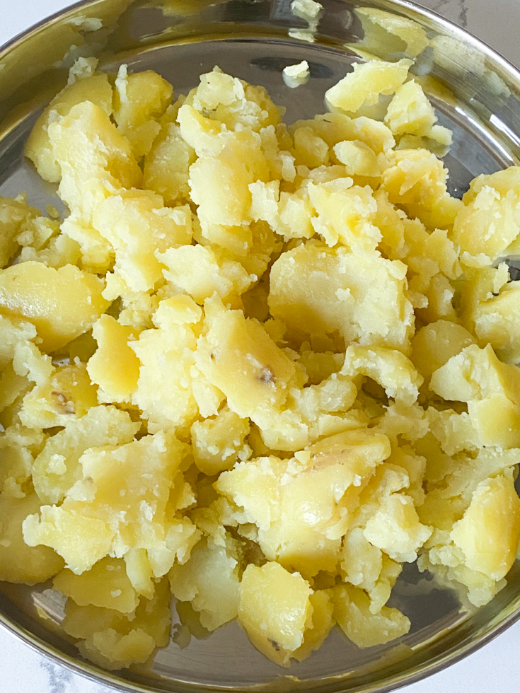 crumbled potatoes in a stainless steel plate
