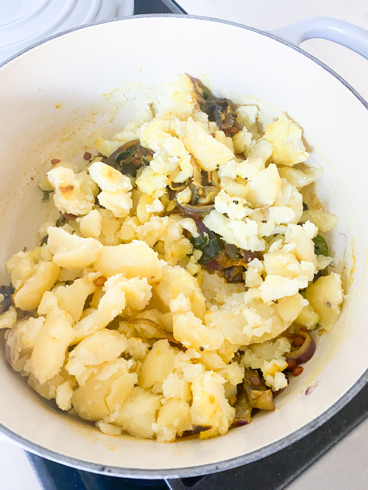 crumbled potatoes added to the enameled cast iron pot