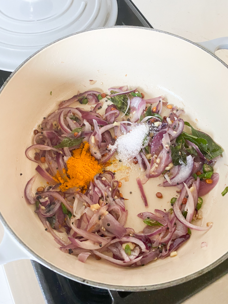 sauteed onions and spices in an enameled cast iron pot