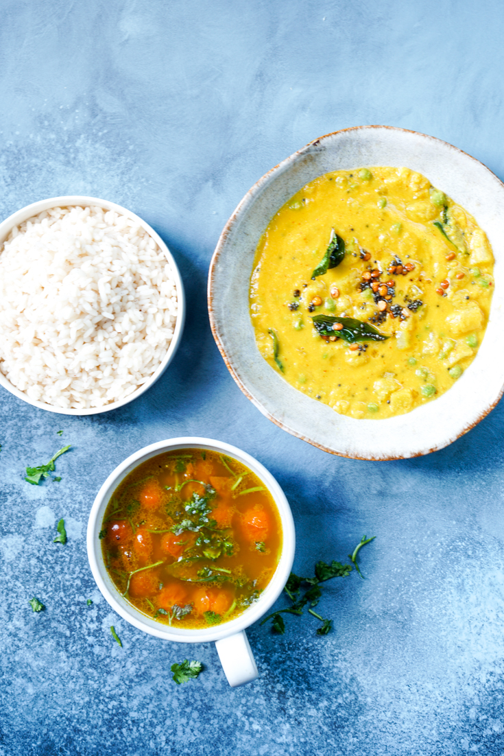 a bowl of rice, dal curry and a cup of rasam soup