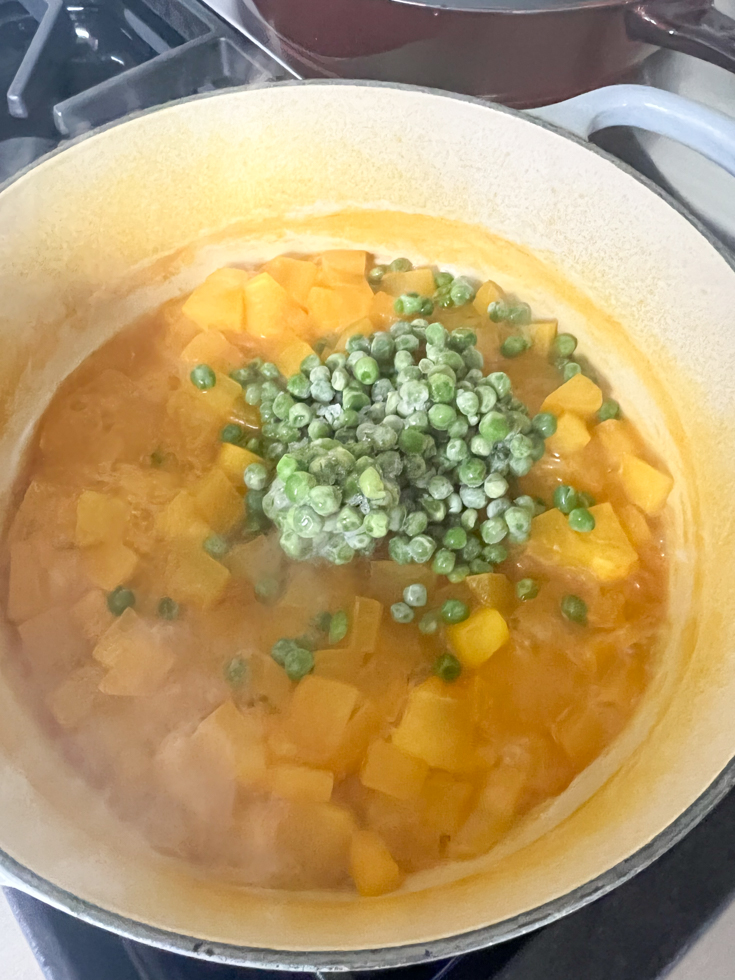 frozen green peas added to pot with cooked pumpkin