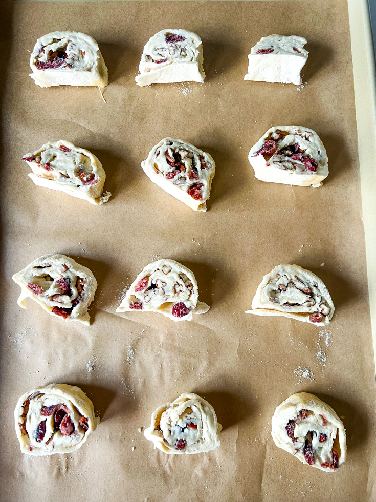 puff pastry pinwheels placed on a baking sheet