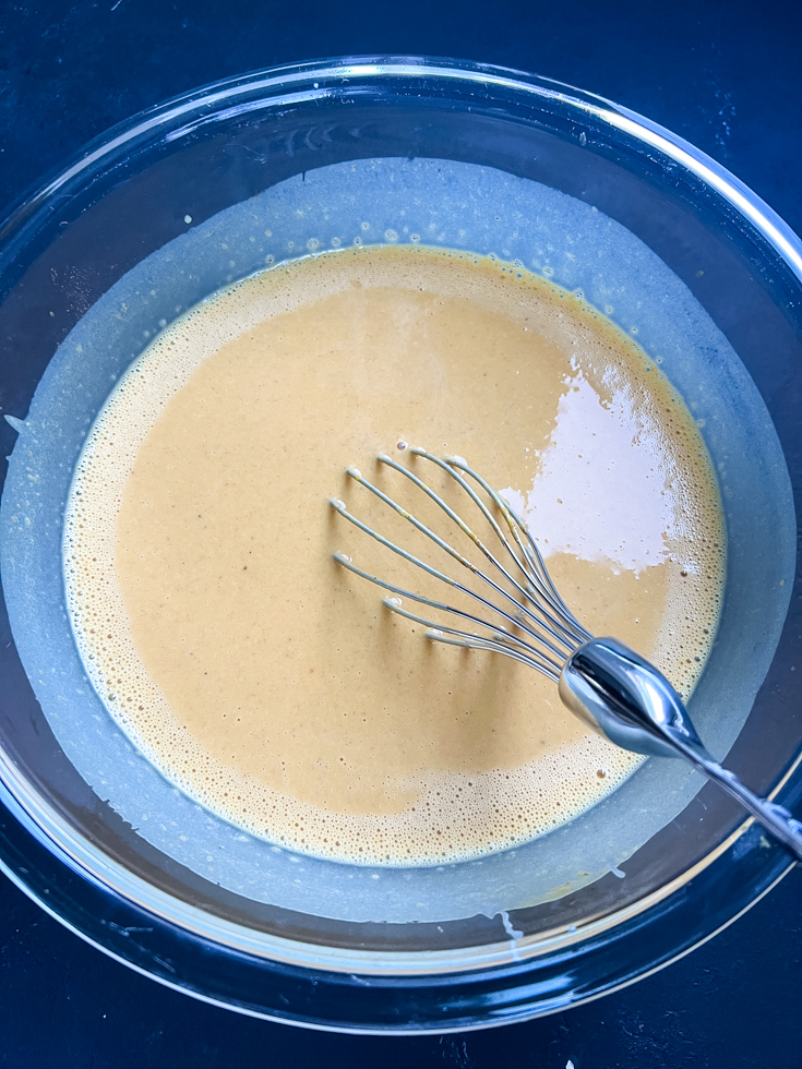 pumpkin custard all mixed up in a glass mixing bowl