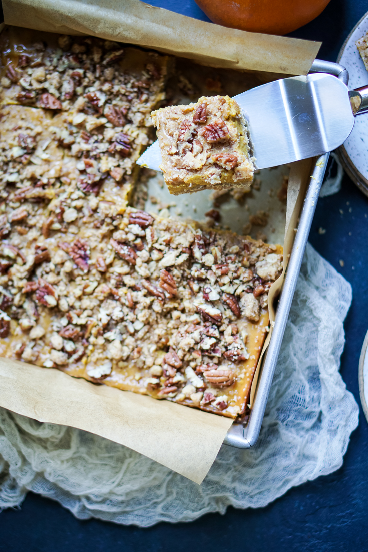 a slice of pumpkin pecan pie bar cut up