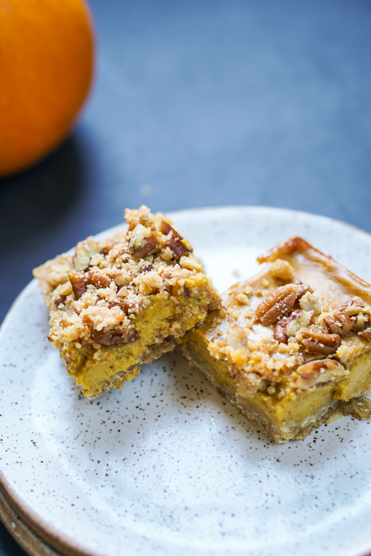 two pumpkin pecan pie bars on a plates