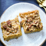 two pumpkin pecan pie bars on a plates