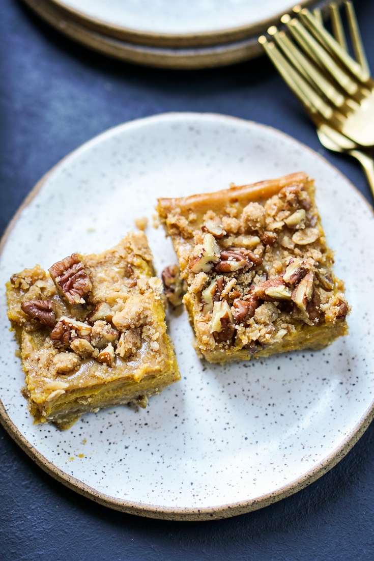 two pumpkin pecan pie bars on a plates