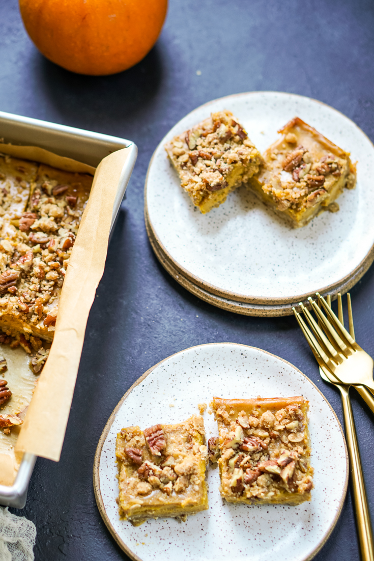 two pumpkin pecan pie bars each on two plates