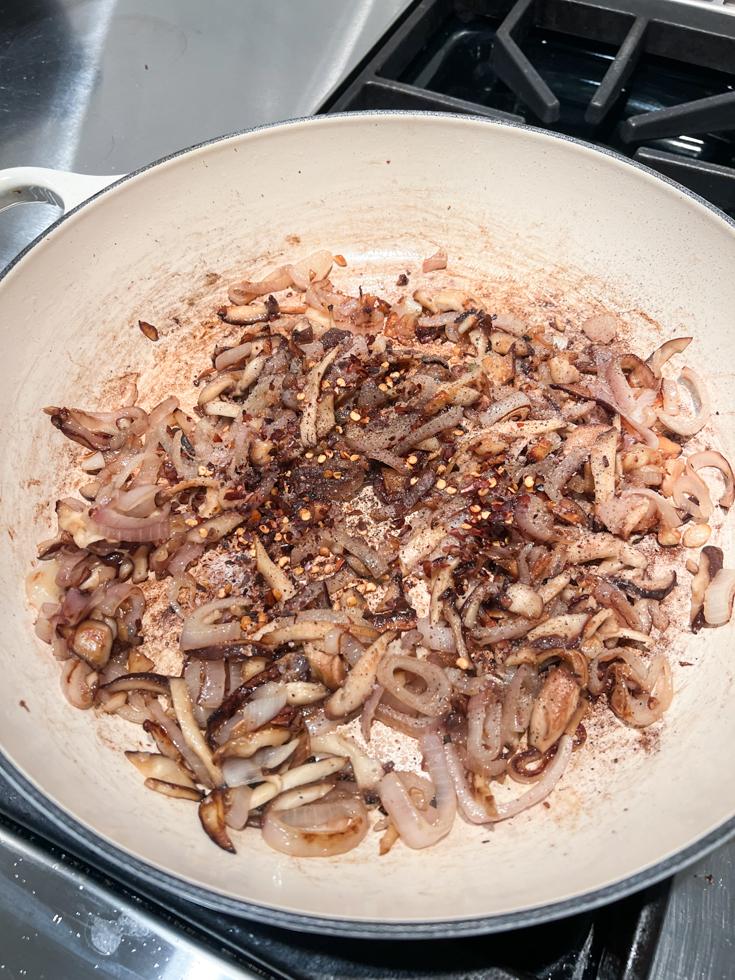 sauteed shallots and mushrooms in a pan