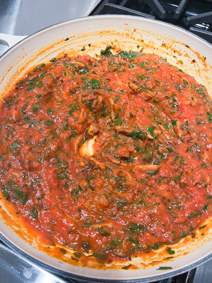 spinach mushroom in marinara sauce in a pan