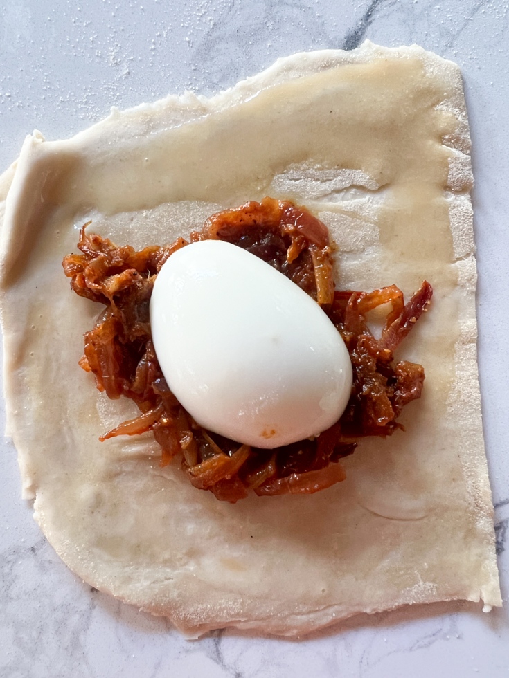 egg and onion mixture on top of a puff pastry square