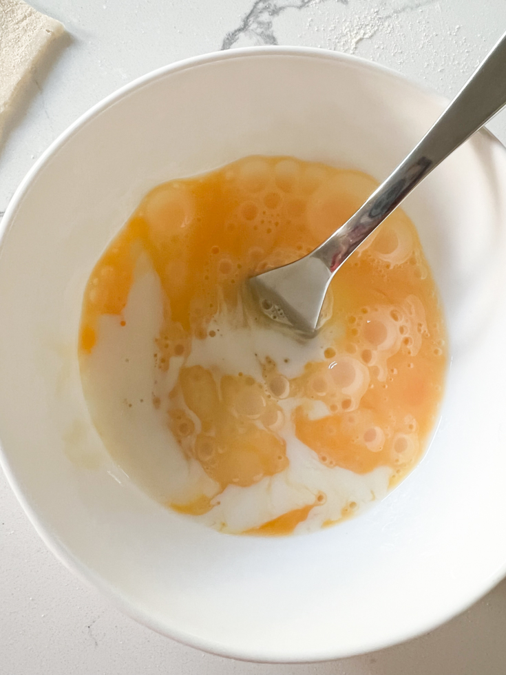 egg and milk in a white bowl