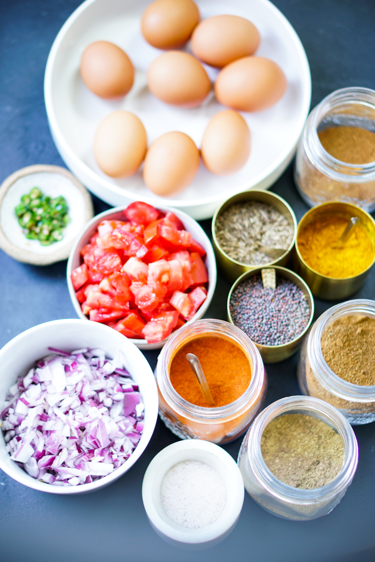 ingredients for egg bhurji laid out on a board