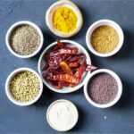 several bowls of various spices kept in a circle