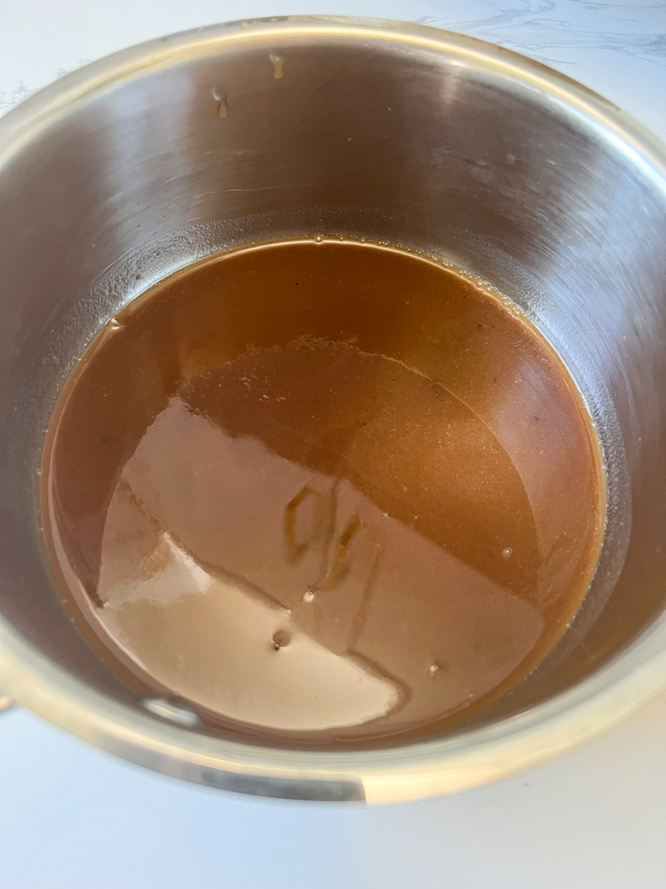 diluted tamarind puree in a stainless steel saucepan