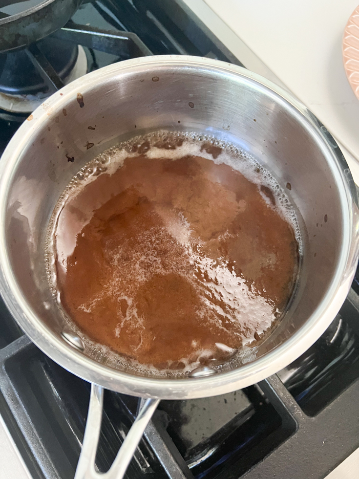 tamarind water boiling in a saucepan on the stovetop