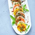 caprese salad in a white platter