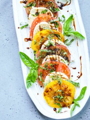 caprese salad in a white platter