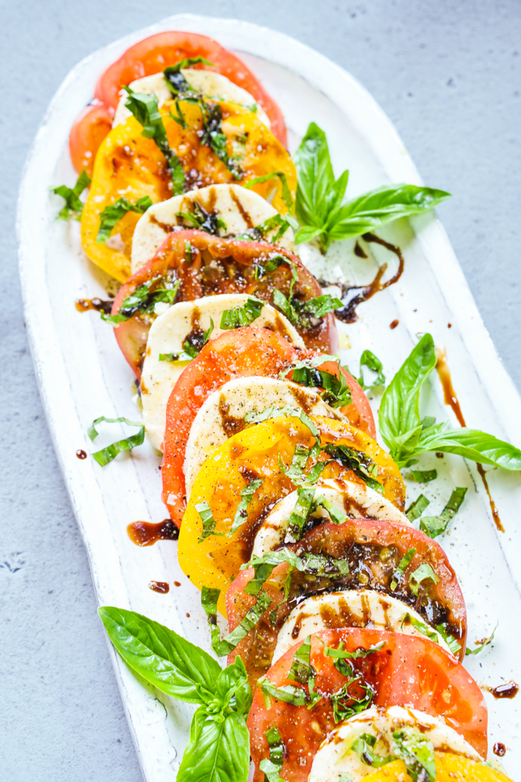 caprese salad in a white platter