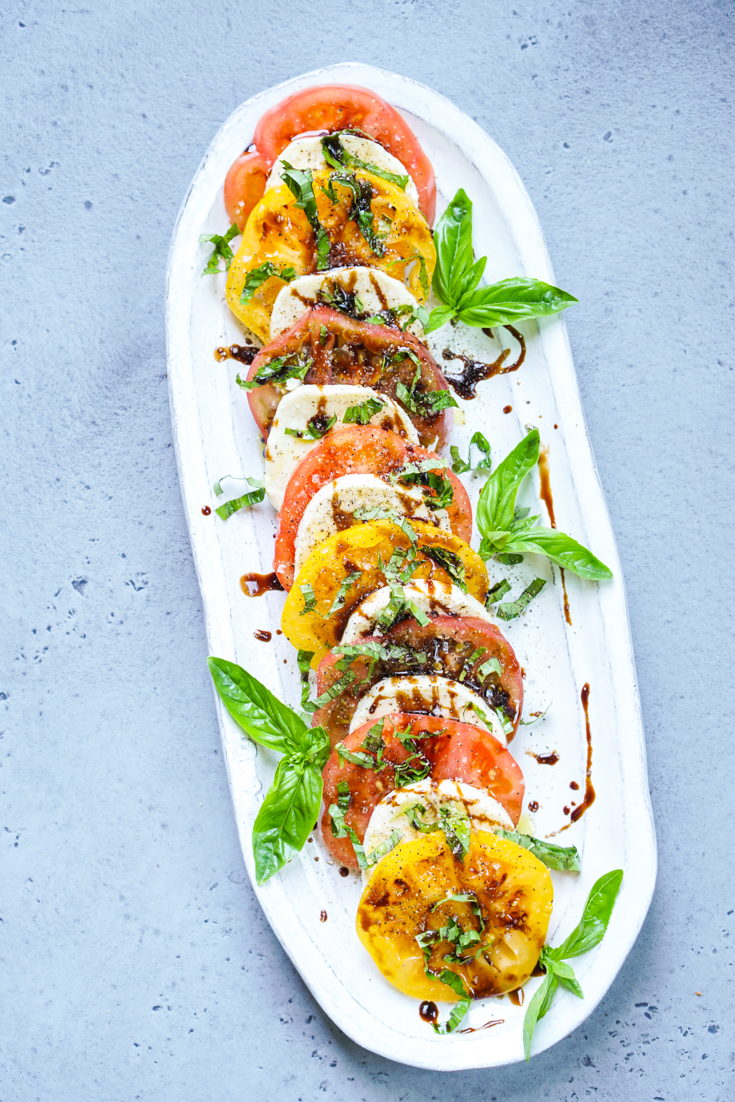 caprese salad in a white platter