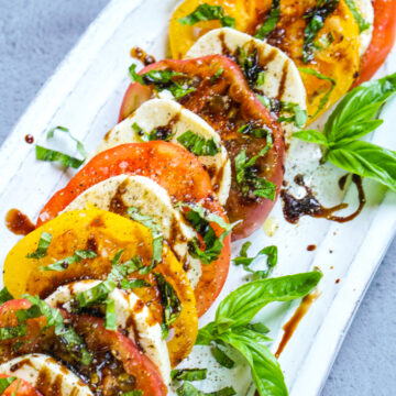 caprese salad in a white platter