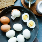 Eggs boiled and peeled in a black plate