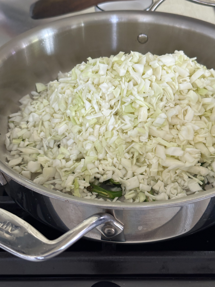 chopped cabbage in a stainless steel pan