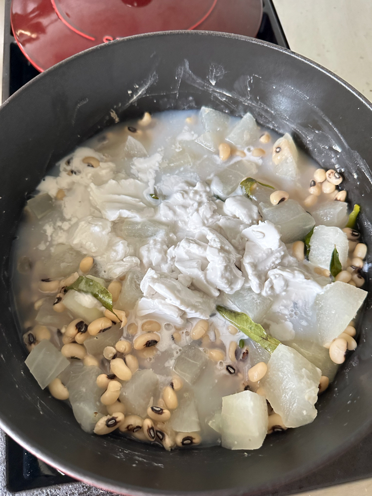 coconut milk poured into olan in a pot