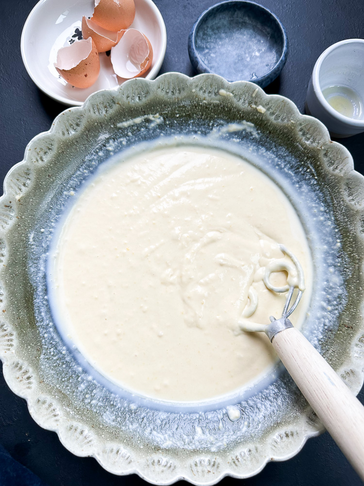 pancake batter in a green mixing bowl