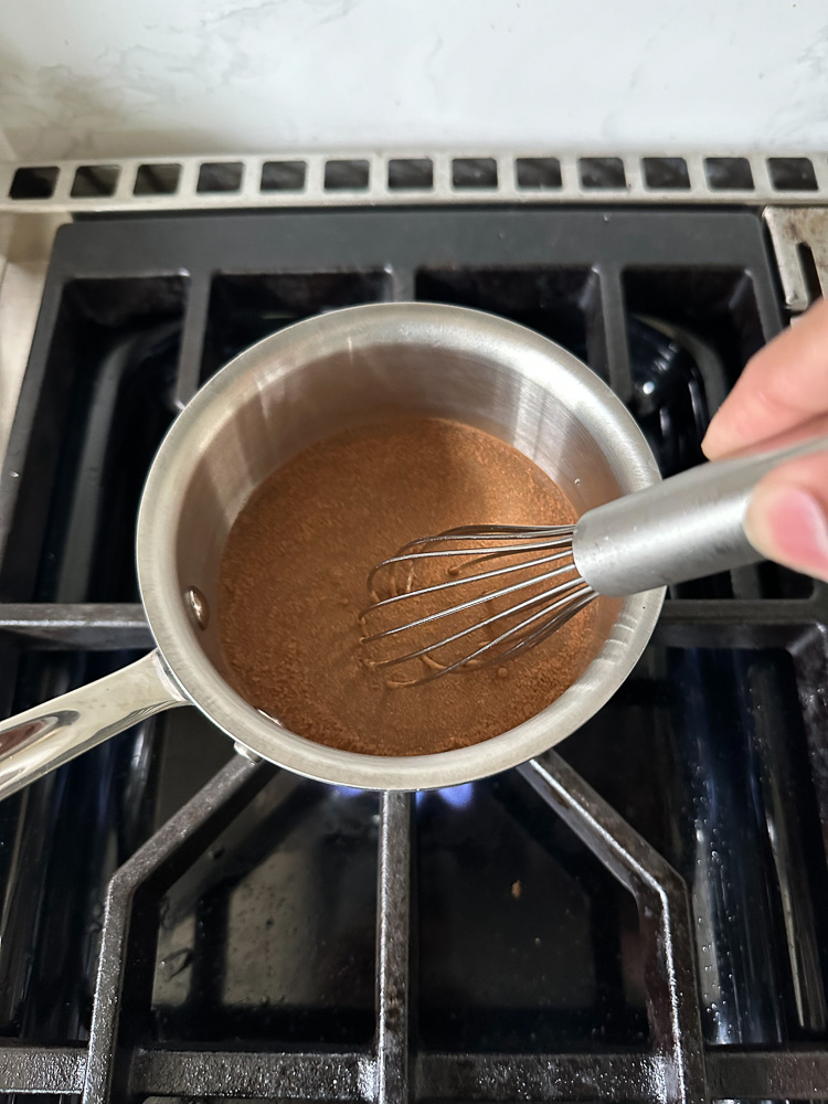 whisking syrup in a sauce pan