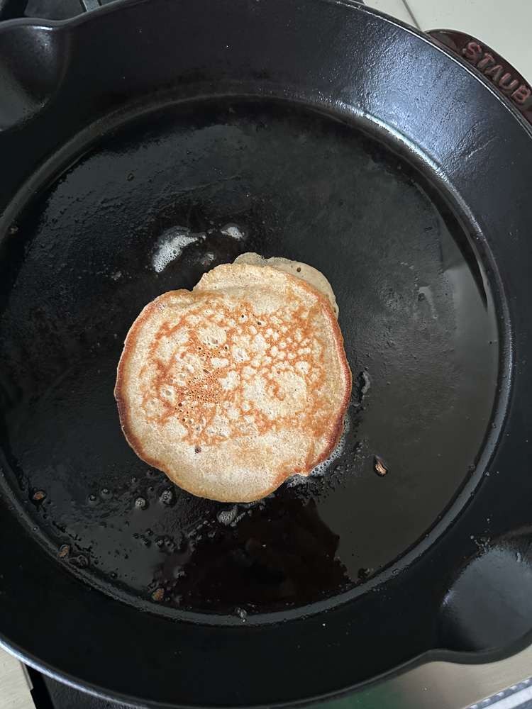 pancake flipped over on a greased skillet